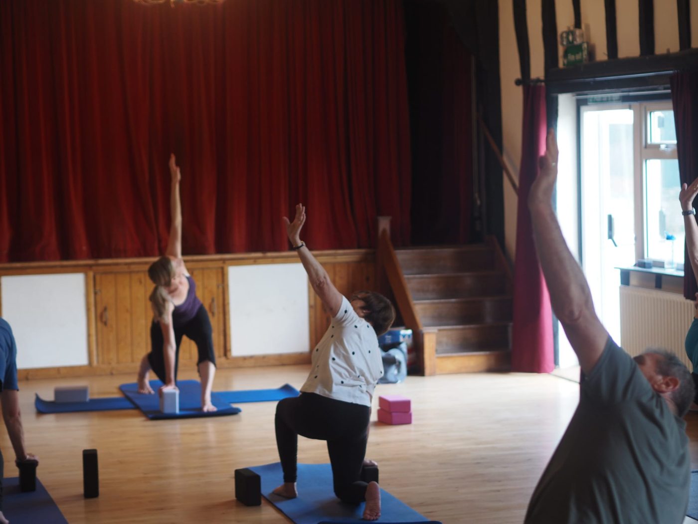 A village-hall class reaching into a side stretch